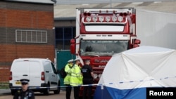 Police is seen at the scene where bodies were discovered in a lorry container, in Grays, Essex, Britain October 23, 2019. REUTERS/Peter Nicholls - 