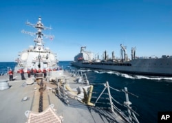 FILE - U.S. Navy, guided-missile destroyer USS Bulkeley participates in a replenishment-at-sea with fleet replenishment oiler USNS John Lenthall in the Gulf of Oman.