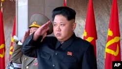 In this image made from video, North Korean leader Kim Jong Un salutes during the ceremony to mark the 70th anniversary of the country's ruling party in Pyongyang, Oct. 10, 2015. 