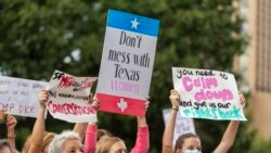 People attend the Women's March ATX rally, at the Texas State Capitol in Austin, Texas, Oct. 2,2021.