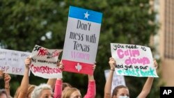 People attend the Women's March ATX rally, at the Texas State Capitol in Austin, Texas, Oct. 2,2021.