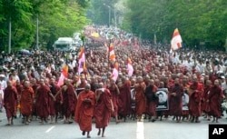 FILE - In this Sept. 24, 2007, file photo, Buddhist monks march on a street to protest the military government in Yangon, Myanmar. The protest was known as the Saffron Revolution.