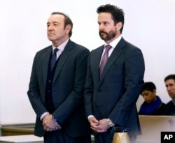 Actor Kevin Spacey stands with his attorney Alan Jackson, right, in district court during arraignment on a charge of indecent assault and battery, Jan. 7, 2019, in Nantucket, Massachusetts.