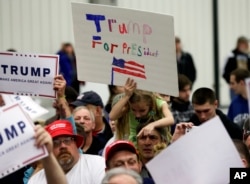 Supporters of Republican presidential candidate Donald Trump try to get autographs after a rally at Griffiss International Airport in Rome, New York, April 12, 2016.