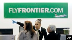 A Frontier Airlines employee wears gloves as she directs passengers where to go at Cleveland Hopkins International Airport . Ohio health officials aren't sure how many people came into contact with the Texas nurse who visited family in the state days before being diagnosed with Ebola.