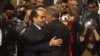 Mustafa Abdel Jalil (R), Chairman of the National Transitional Council (NTC) shakes hands with war-time Prime Minister Mahmoud Jibril after handing over power to the national congress in Tripoli August 8, 2012