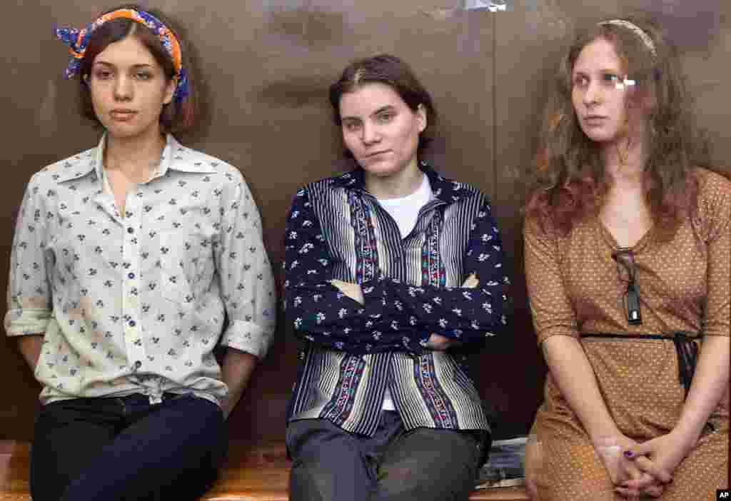 August 3: Pussy Riot members, from left, Nadezhda Tolokonnikova, Yekaterina Samutsevich and Maria Alekhina sit in a glass cage at a court room in Moscow, Russia. 