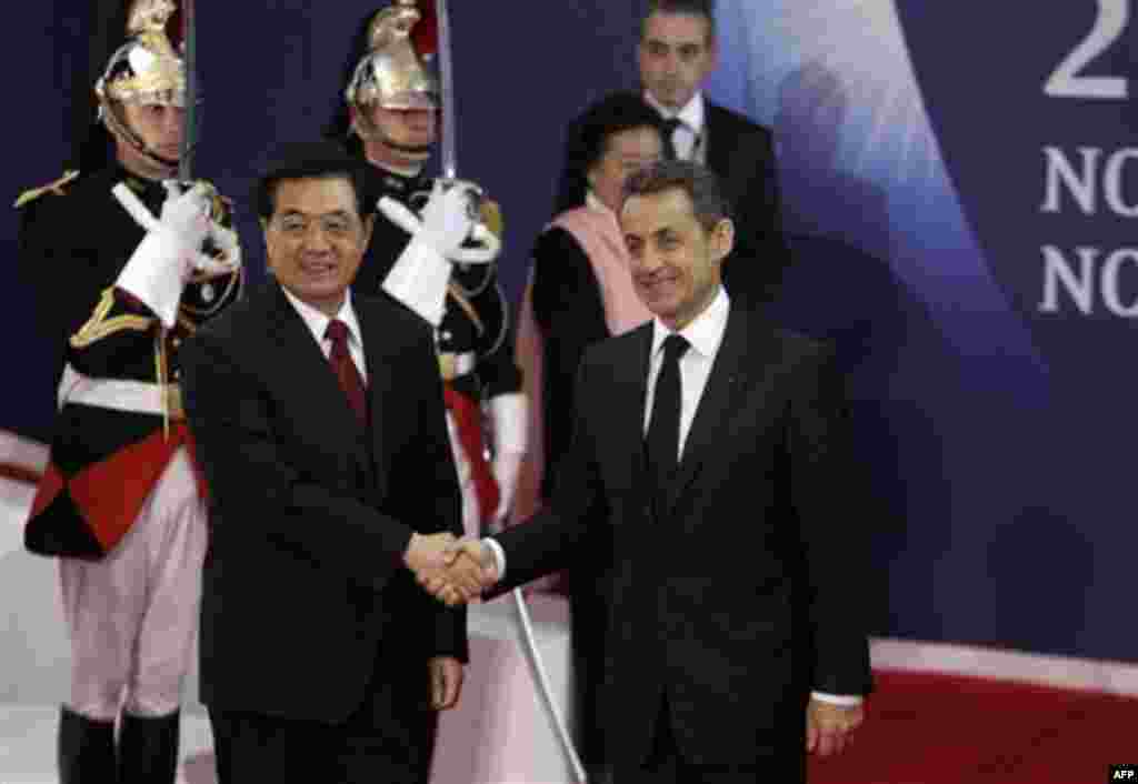 French President Nicolas Sarkozy, right, shakes hands with China's President Hu Jintao during arrivals for the G20 summit in Cannes, France on Wednesday, Nov. 2, 2011. Greek Prime Minister George Papandreou was flying to the chic French Riviera resort of 