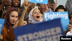 FILE - Young Muslim women listen to Democratic candidate Hillary Clinton speak at a voter registration rally in Detroit, Michigan, Oct. 10, 2016. Out of some 3.3 million Muslims living in America, about 1.5 million are eligible to vote, data shows.