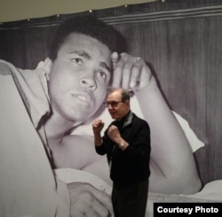 George Kalinsky, who photographed Ali for 50 years, standing In front of his photo. (New York Historical Society)