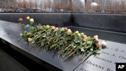 Roses are placed on the 9/11 Memorial during 25th anniversary ceremony to commemorate the six victims of the 1993 World Trade Center bombing, in New York, Feb. 26, 2018.