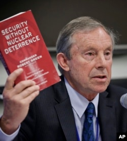 Former U.K. Naval commander Rob Green, co-director of Peace Foundation's Disarmament and Security Centre, displays his book as he speaks during a press briefing by experts on nuclear disarmament, discussing a new treaty to ban nuclear weapons, July 5, 2017.