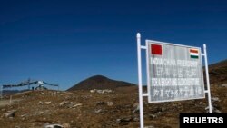 A signboard is seen from the Indian side of the Indo-China border at Bumla, in the northeastern Indian state of Arunachal Pradesh.
