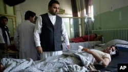 Wounded men lie on their beds in Wazir Akbar Khan Hospital in Kabul, Afghanistan, May 31, 2017. A massive explosion rocked a highly secure diplomatic area of Kabul Wednesday morning, causing casualties and sending a huge plume of smoke over the Afghan capital.