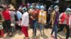 Cambodian garment workers on a lunch break outside of Propitious (Cambodia) Garment Ltd. in Kandal province, Cambodia, March 20, 2020. (Kann Vicheika/VOA Khmer) 