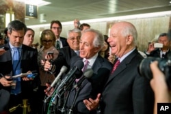 FILE -Senate Foreign Relations Committee Chairman Sen. Bob Corker, R-Tenn., (C) and the committee's ranking member Sen. Ben Cardin, D-Md. speak to reporters on Capitol Hill in Washington, April 14, 2015, as the Senate muscled its way into President Barack