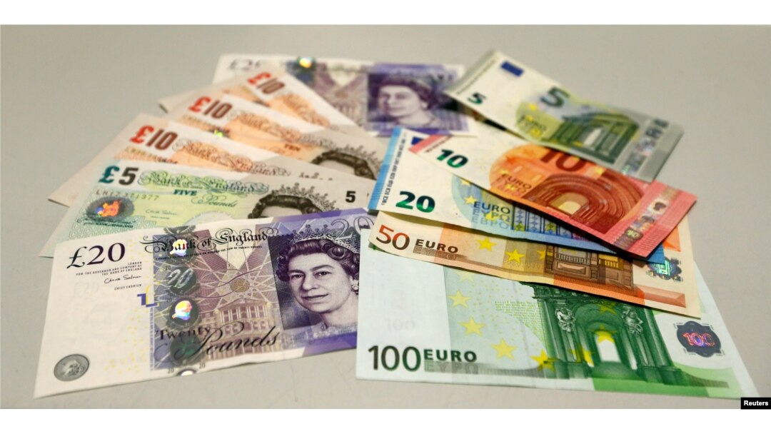 FILE - British pounds and Euro banknotes are pictured in a bank at the main train station in Munich, Germany, June 24, 2016 after Britain voted to leave the European Union in the EU BREXIT referendum.