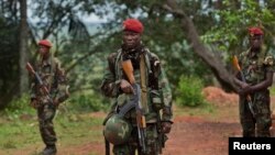 FILE - Troops from the Central African Republic stand guard at a building used for joint meetings where U.S. special forces have paired up with local troops and Ugandan soldiers to seek out Joseph Kony's Lord's Resistance Army, in Obo, Central African Republic.