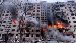 Rescuers work next to a residential building damaged by shelling, as Russia's attack on Ukraine continues, in Kyiv, March 14, 2022. (State Emergency Service of Ukraine/Reuters)