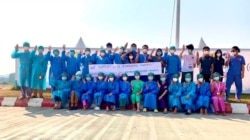 Healthcare workers pose for a picture at the Ayawaddy coronavirus disease (COVID-19) treatment center in Mandalay, Myanmar February 3, 2021. Prof Cho Mar Lwin/Handout via REUTERS ATTENTION EDITORS - THIS IMAGE HAS BEEN SUPPLIED BY A THIRD PARTY. NO RESALE