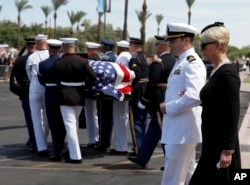 Cindy McCain walks with her son Jack as the honor guard carries the casket after a memorial service for Sen. John McCain, R-Ariz. at the North Phoenix Baptist Church on Aug. 30, 2018, in Phoenix, Ariz.