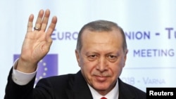FILE - Turkish President Tayyip Erdogan waves during a news conference at Euxinograd residence, near Varna, Bulgaria, March 26, 2018.