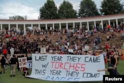 Protesters gather at Lambeth Field at the University of Virginia ahead of the one year anniversary of the 2017 Charlottesville "Unite the Right" protests, in Charlottesville, Va., Aug. 11, 2018. The heavy security presence this year angered some students.