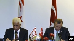 Turkish PM Recep Tayyip Erdogan and Turkish Cypriot Leader Dervish Eroglu (L) attend a signing ceremony in New York on September 21, 2011 for a deal for offshore gas exploration in the Mediterranean