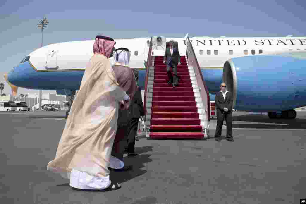 U.S. Secretary of State John Kerry is met by Qatari Chief of Protocol Abdullah Fakhroo and Qatari Ambassador to the U.S. Mohamed al-Rumaihi at Doha International Airport, March 5, 2013.