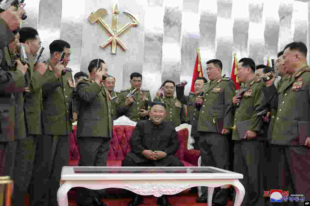 North Korean leader Kim Jong Un, sitting center, is surrounded by senior military officials holding &ldquo;Paektusan&rdquo; commemorative pistols they received from him during a ceremony in Pyongyang, July 26, 2020. (Photo released by the North Korean Government)