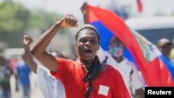 FILE - A man protesting the deportation of Haitian migrants by the United States marches toward the U.S. Embassy, in Port-au-Prince, Haiti, Sept. 26, 2021.