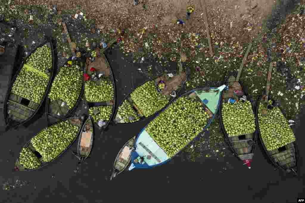 This aerial picture shows workers unloading watermelons from boats in Burigonga river during a government-ordered lockdown as a preventative measure against the spread of the COVID-19 coronavirus in Dhaka, Bangladesh.