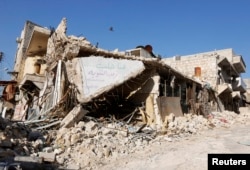 FILE - A damaged building is pictured in Masaken Hanano, Aleppo, April 2, 2014.