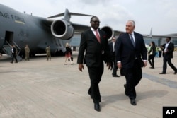 Nigeria's Ministry of Foreign Affairs, the Permanent Secretary Olukunle Bamgbose walks with U.S. Secretary of State Rex Tillerson as he arrives in Abuja, Nigeria, March 12, 2018.