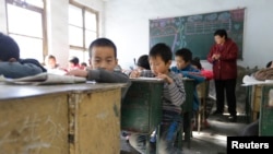 FILE - Students attend class at Pengying School on the outskirts of Beijing.