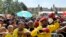 FILE - People attend 20-year Democracy Anniversary celebrations near to the government's Union Building, background, in Pretoria, South Africa, Sunday, April 27, 2014.