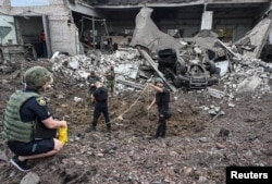 Police experts work at a site of a Russian missile strike in Kryvyi Rih, Ukraine, on Aug. 28, 2024.