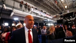 FILE - Sen. Cory Booker works his way through the spin room after the 2020 Democratic U.S. presidential debate in Houston, Sept. 12, 2019.