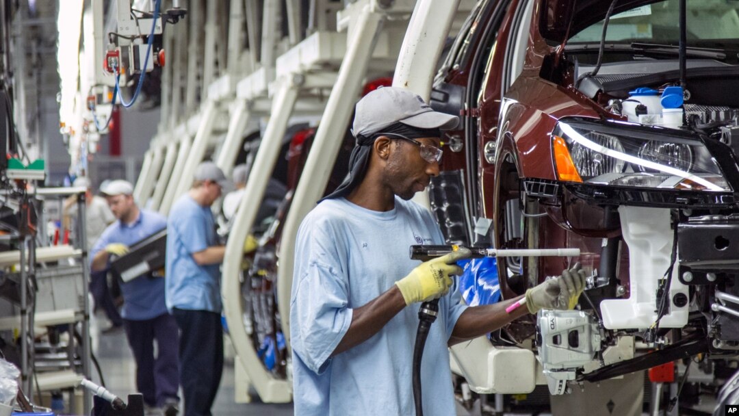 FILE - Employees at the Volkswagen plant in Chattanooga, Tenn., work on the assembly of a Passat sedans, July 12, 2013. 