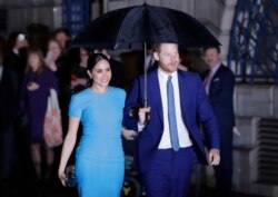 FILE -- Britain's Prince Harry and Meghan, the Duke and Duchess of Sussex, arrive at the annual Endeavour Fund Awards in London on March 5, 2020.