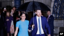 FILE - Britain's Prince Harry and Meghan, the Duke and Duchess of Sussex, arrive at an event in London, March 5, 2020. 