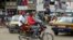 FILE - A motorbike taxi rides past Mokolo Market in Yaounde, Cameroon, Oct. 11, 2018.