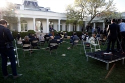 President Donald Trump speaks about the coronavirus in the Rose Garden of the White House, March 30, 2020, in Washington.