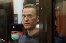 FILE - An image from video shows Russian opposition leader Alexey Navalny, who is accused of flouting terms of a suspended sentence for embezzlement, during the announcement of a court verdict in Moscow, Feb. 2, 2021.
