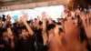 FILE - Pro-democracy supporters celebrate after pro-Beijing candidate Junius Ho lost a seat in the district council elections in Tuen Mun district of Hong Kong, early on Nov. 25, 2019.