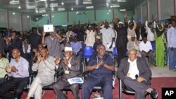 Somalis react in favour of Somalia's new draft constitution, in Mogadishu, Somalia,Wednesday, Aug. 1, 2012. Somali leaders voted overwhelmingly on Wednesday to adopt a new constitution that contains new individual rights and sets the country on a course f