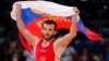 Russia's Dzhamal Otarsultanov celebrates after defeating Georgia's Vladimer Khinchegashvili on the final of the Men's 55Kg Freestyle wrestling during the London 2012 Olympic Games Aug. 10, 2012.