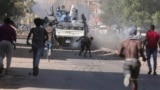 FILE: Sudanese confront the police during a protest against the military coup that ousted government last month, in Khartoum, Sudan. Taken Wed., Nov. 17, 2021.