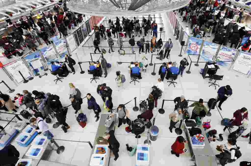 Travelers line up for a security checkpoint at John F. Kennedy International Airport in New York. The airline industry trade group Airlines for America expects that Wednesday will be the second-busiest day of the holiday period, when many travelers will be returning home after Thanksgiving.