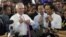 Australian Prime Minister Malcolm Turnbull, left, and Indonesian President Joko Widodo loosen their ties as they visit the Tanah Abang retail market in Jakarta, Nov. 12, 2015.